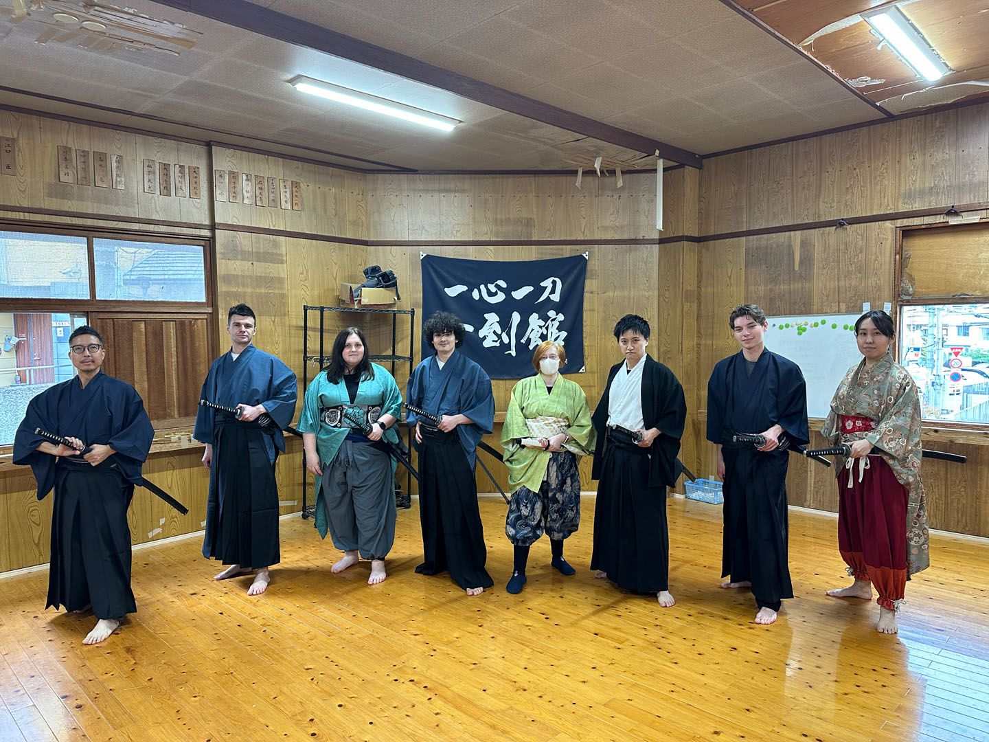 Language student practices with a Katakana Sword in traditional clothing